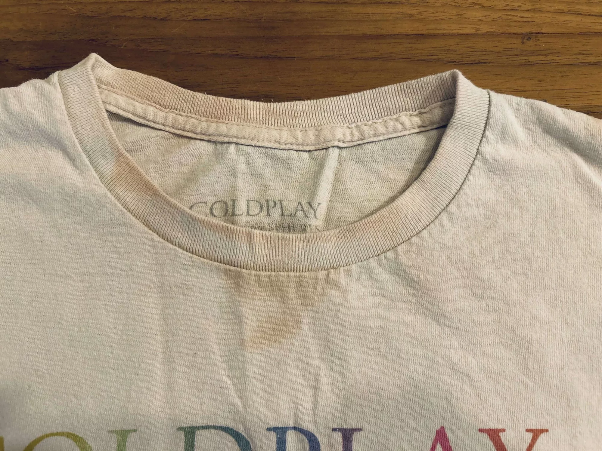 Coldplay t-shirt stained yellow by sunscreen, Juniper Hill Cleaners best cleaning tips